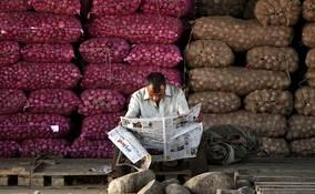 Worker reads newspaper 1445 half